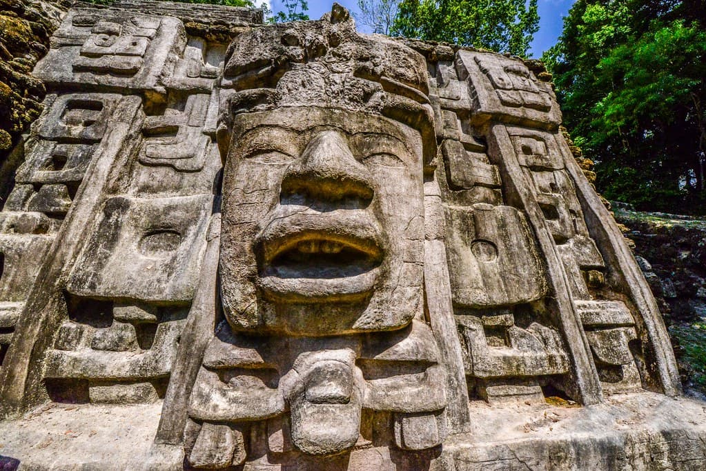 Ancient Maya temple at Lamanai rising above the jungle